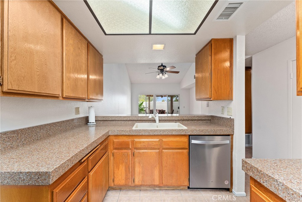 1159 Stone Pine Lane, Unit C Corona, CA 92879 - Photo 6 of 25 a kitchen with stainless steel appliances granite countertop a sink and a stove