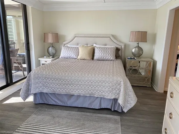 a bedroom with two beds and a large mirror