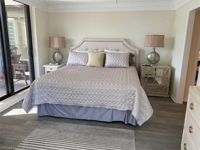 a bedroom with two beds and a large mirror