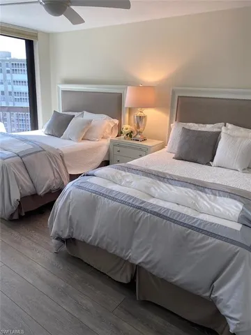 a bedroom with a large bed and a flat tv screen on a dresser