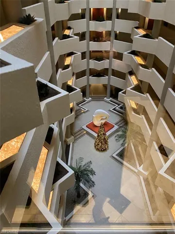 a view of swimming pool with a yard and palm trees