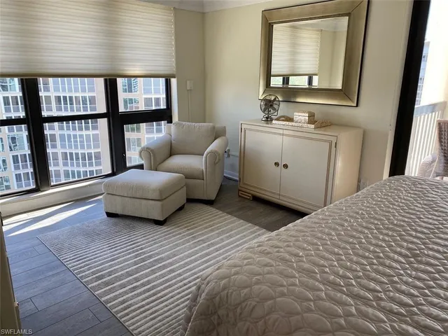 a living room with furniture and a floor to ceiling window