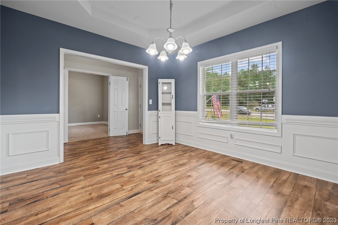 376 Tactical Drive Bunnlevel, NC 28323 - Photo 14 of 46 a view of an empty room with wooden floor and a window