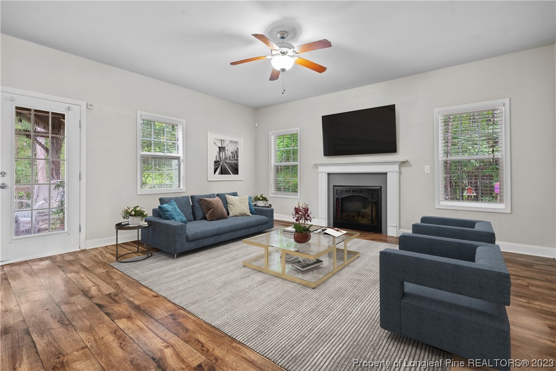 376 Tactical Drive Bunnlevel, NC 28323 - Photo 15 of 46 a living room with furniture a flat screen tv and a fireplace