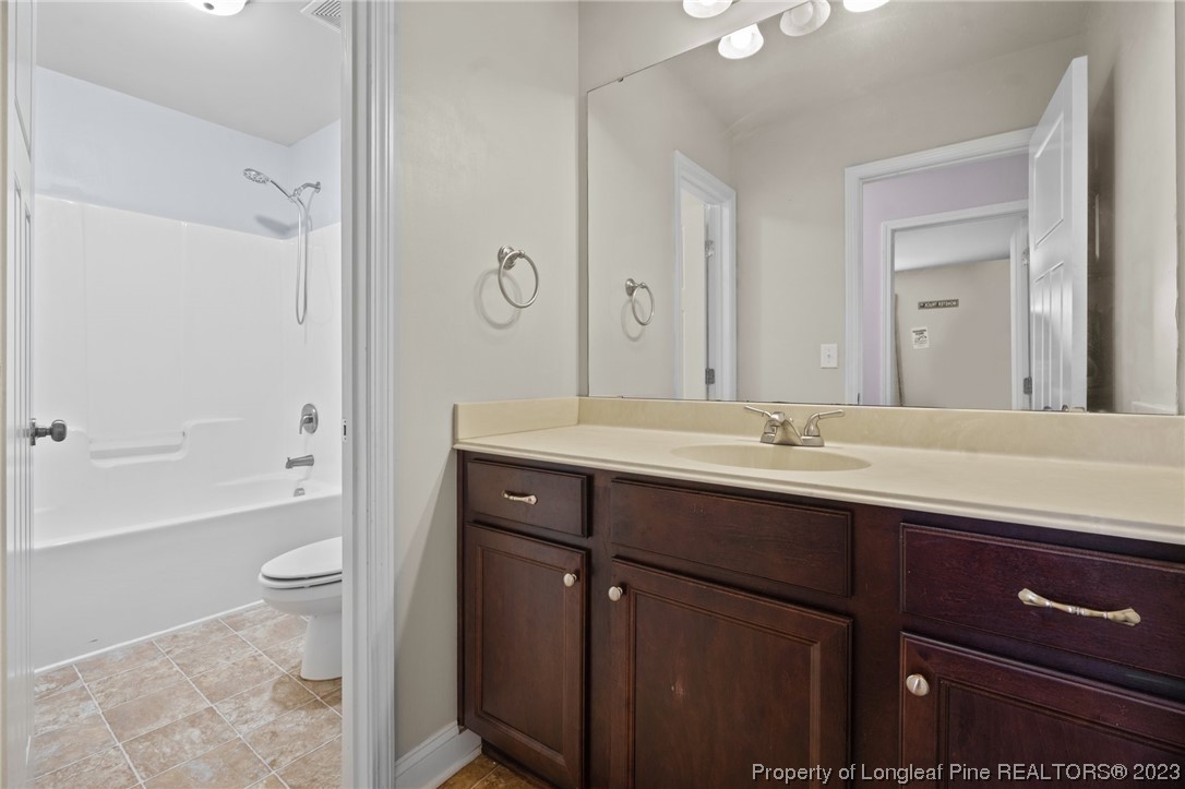376 Tactical Drive Bunnlevel, NC 28323 - Photo 17 of 46 a bathroom with a granite countertop sink toilet and shower