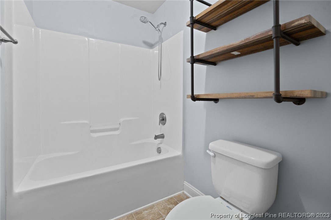 376 Tactical Drive Bunnlevel, NC 28323 - Photo 20 of 46 a white toilet sitting next to a bath tub