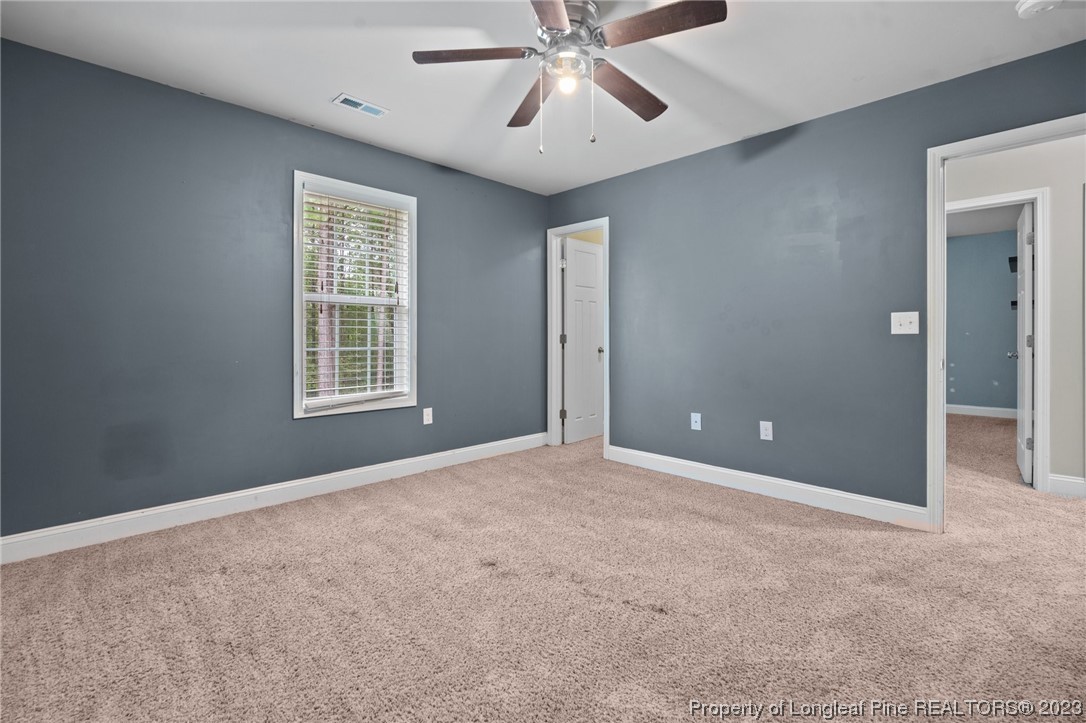 376 Tactical Drive Bunnlevel, NC 28323 - Photo 22 of 46 an empty room with windows and fan