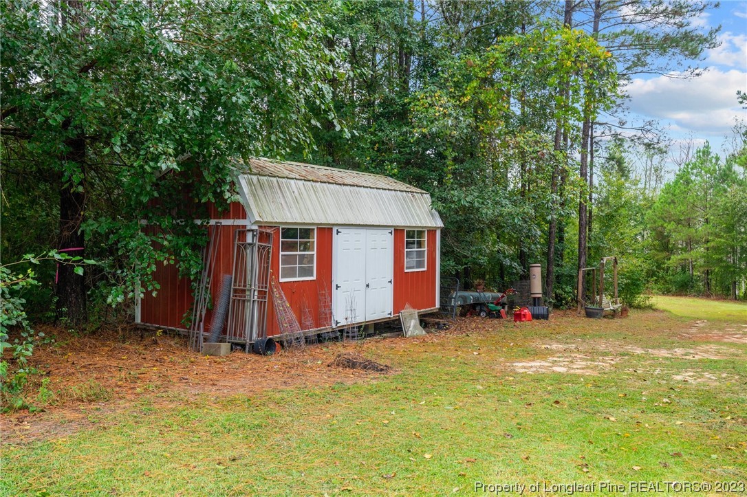 376 Tactical Drive Bunnlevel, NC 28323 - Photo 33 of 46 a view of a barn in the middle of a yard