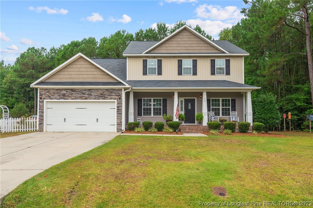 376 Tactical Drive Bunnlevel, NC 28323 - Photo 35 of 46 a front view of a house with a yard and garage