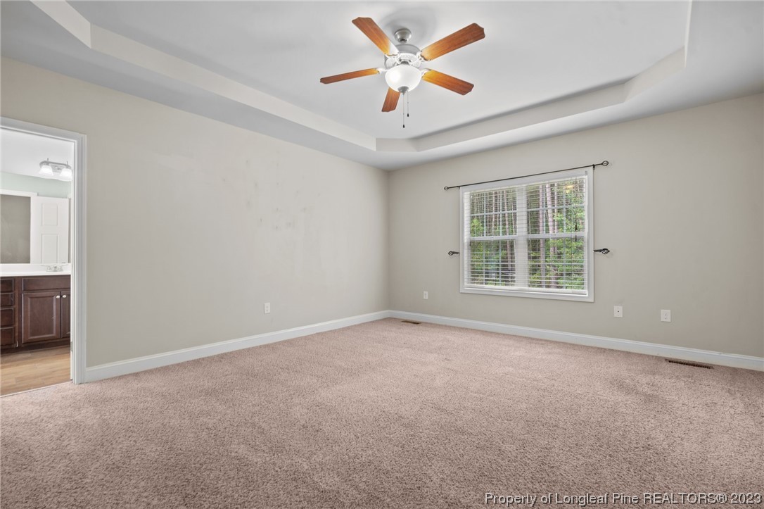376 Tactical Drive Bunnlevel, NC 28323 - Photo 38 of 46 an empty room with a window and a ceiling fan