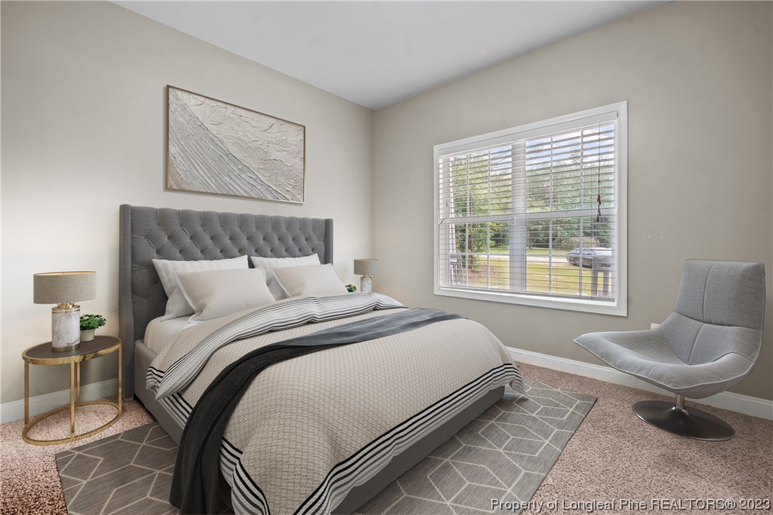 376 Tactical Drive Bunnlevel, NC 28323 - Photo 42 of 46 a bedroom with a bed and glass window