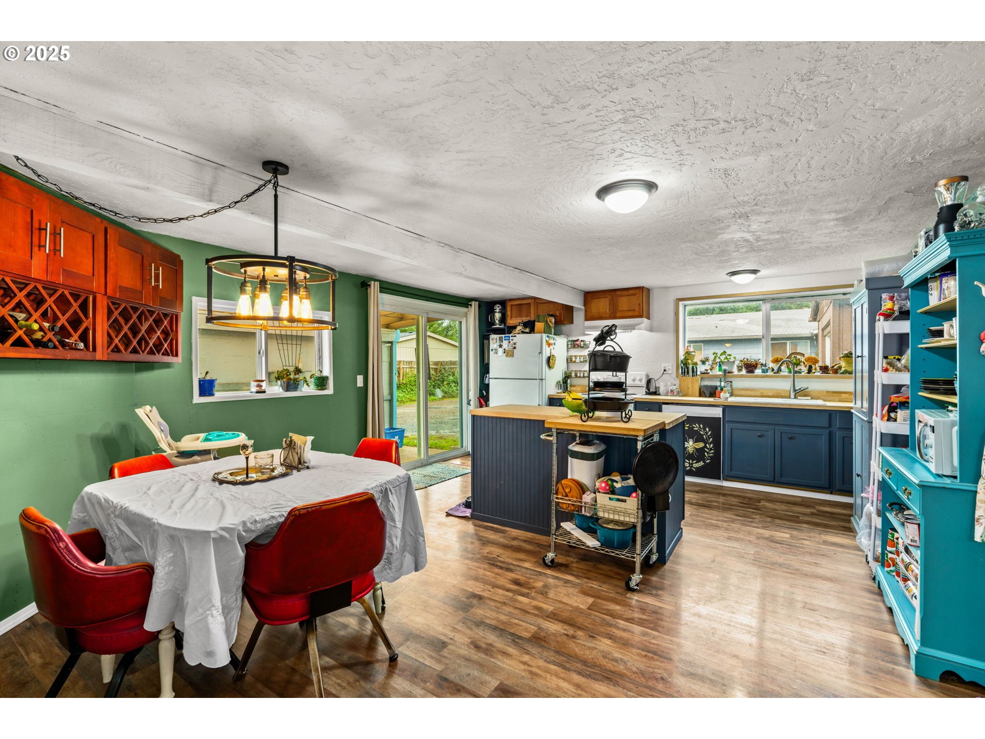 5736 A Street Springfield, OR 97478 - Photo 8 of 26 a view of a dining room with furniture and a chandelier