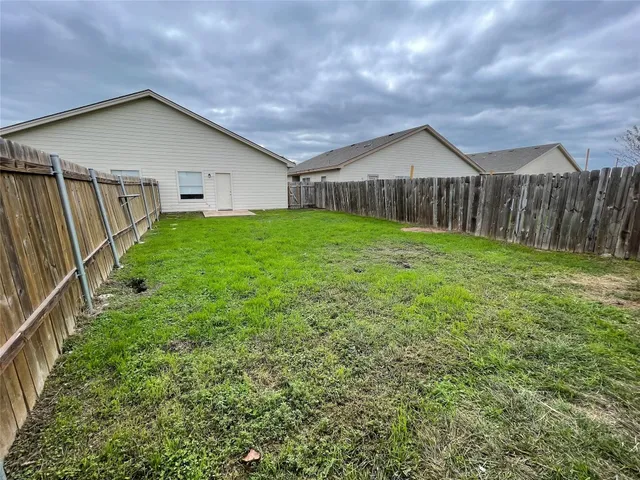 a view of a house with wooden fence