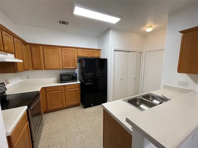 a kitchen with a refrigerator stove and sink