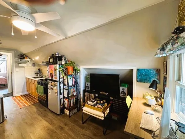 a view of a livingroom with furniture and a flat screen tv