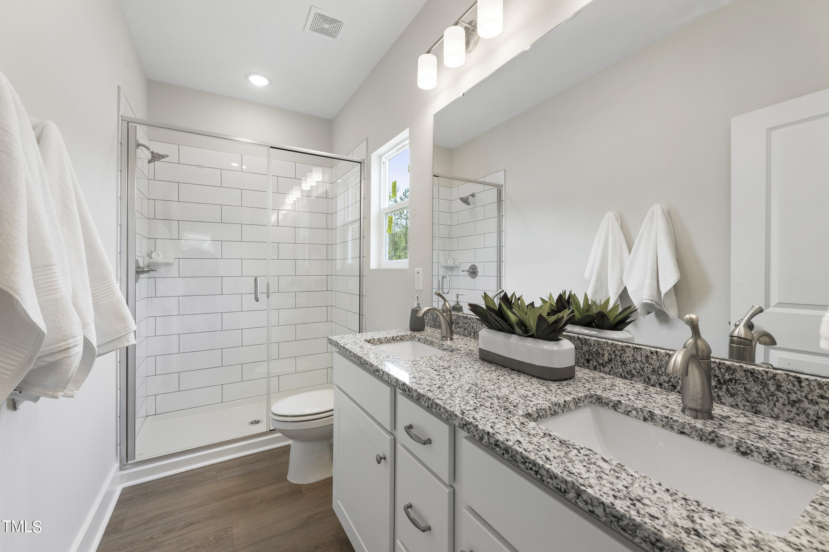 25 Chester Lane Middlesex, NC 27557 - Photo 18 of 32 a bathroom with a granite countertop sink a toilet and shower