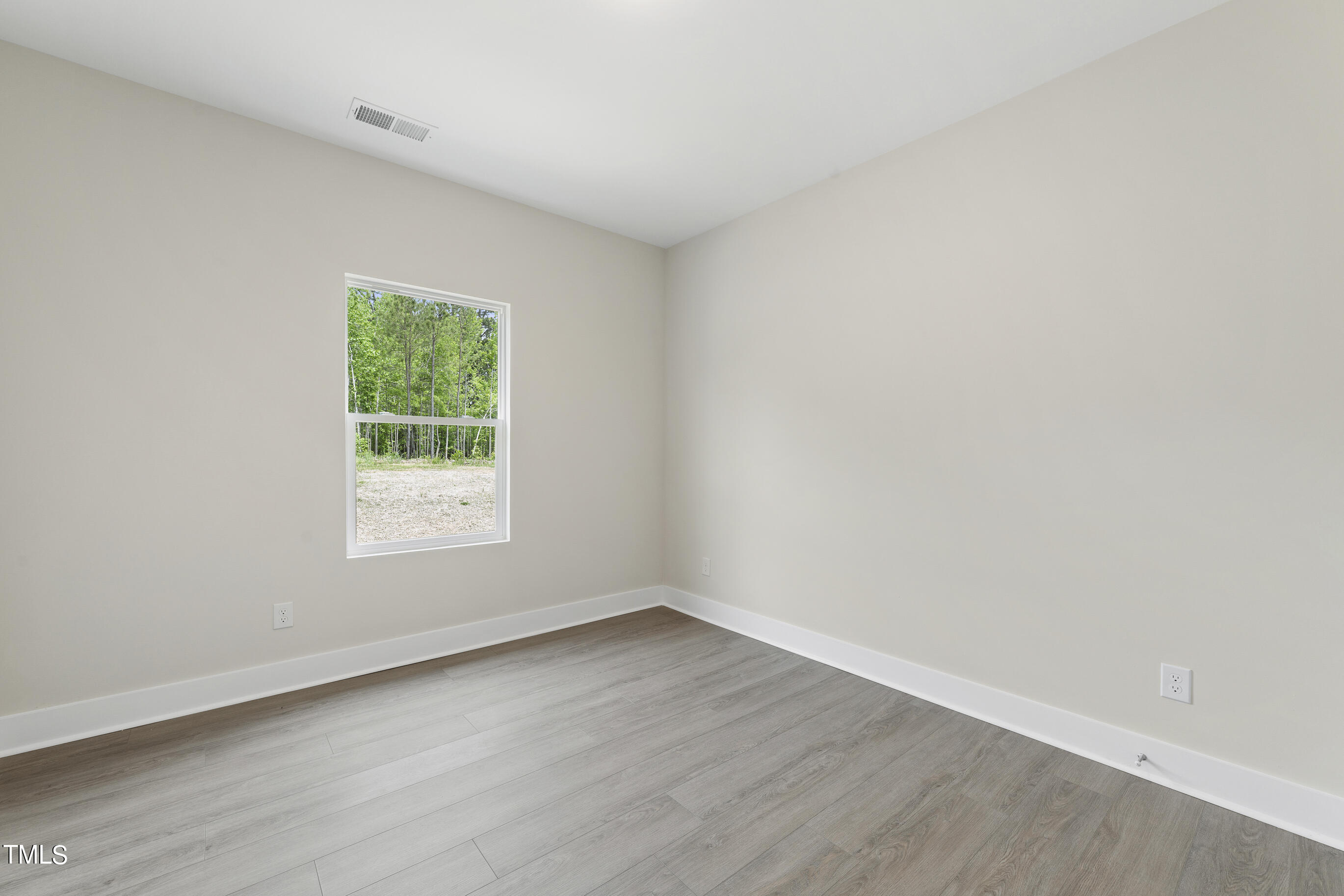 25 Chester Lane Middlesex, NC 27557 - Photo 20 of 32 an empty room with wooden floor and windows