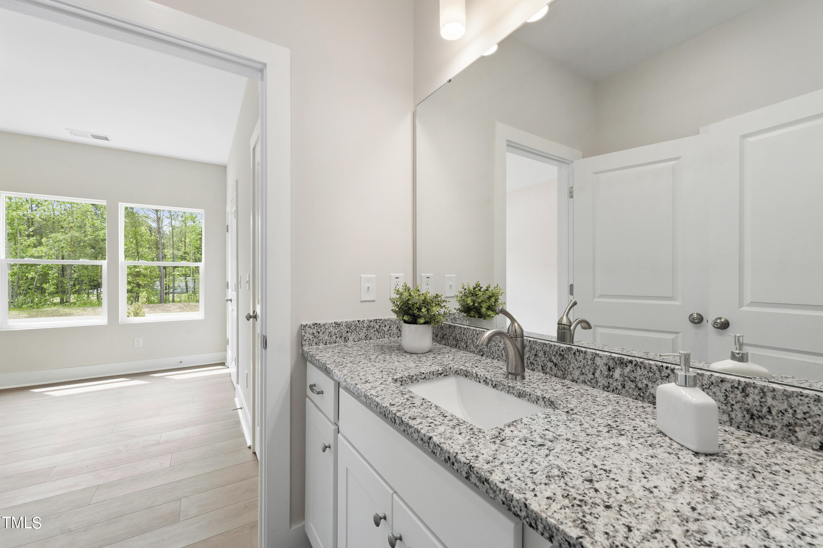 25 Chester Lane Middlesex, NC 27557 - Photo 22 of 32 a bathroom with a granite countertop sink and a large mirror