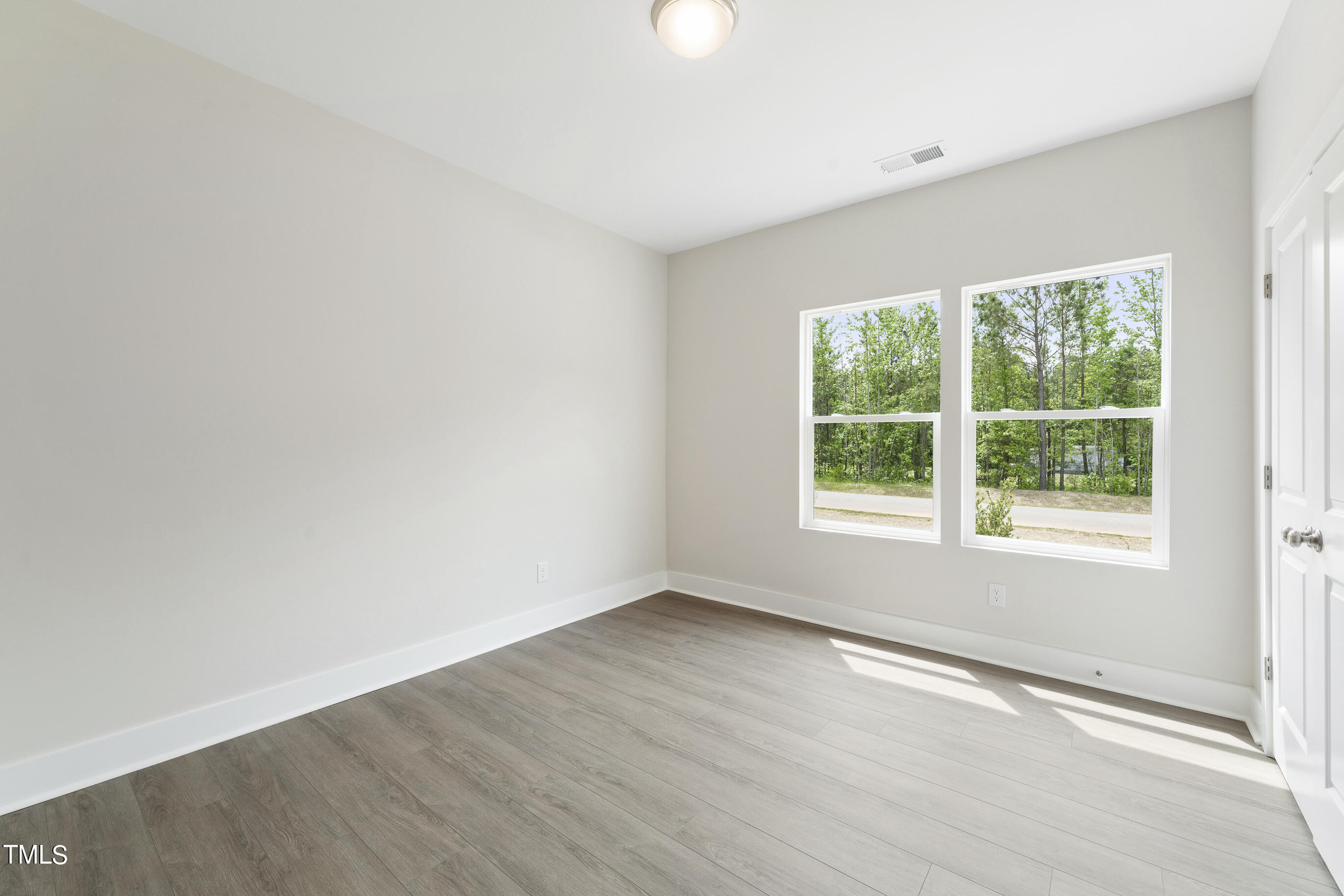 25 Chester Lane Middlesex, NC 27557 - Photo 24 of 32 an empty room with wooden floor and windows