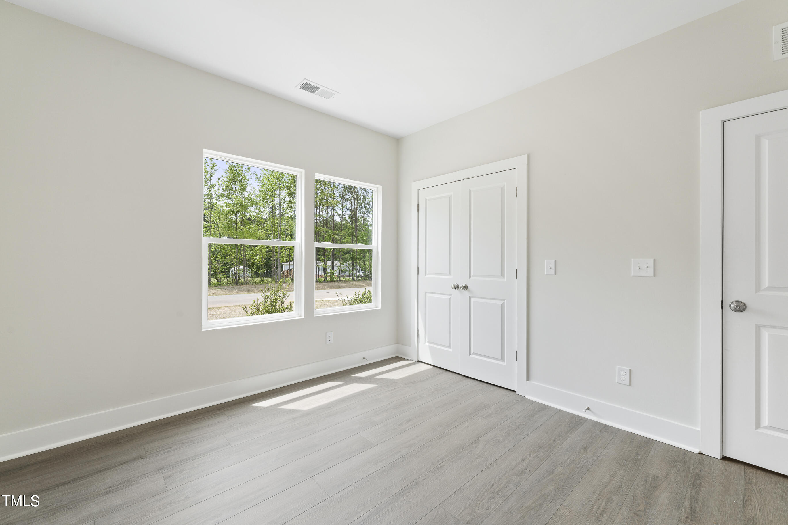 25 Chester Lane Middlesex, NC 27557 - Photo 25 of 32 an empty room with wooden floor and window