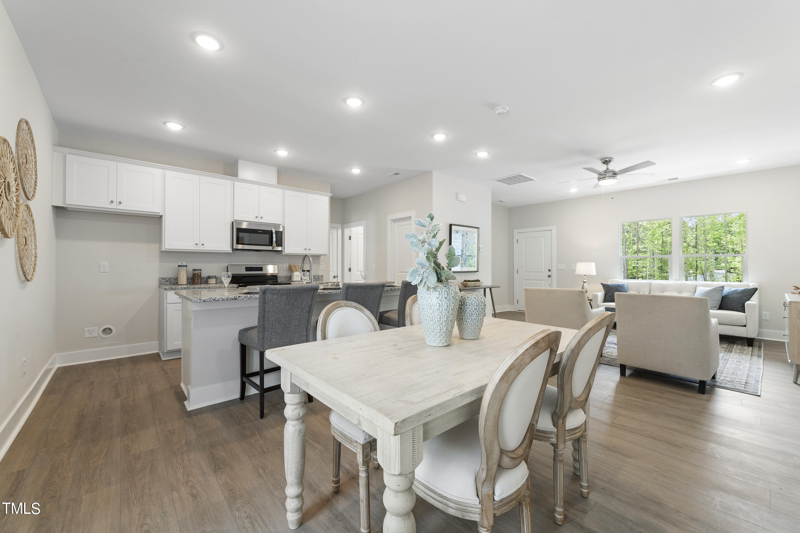 25 Chester Lane Middlesex, NC 27557 - Photo 10 of 32 a kitchen with a dining table chairs refrigerator and cabinets