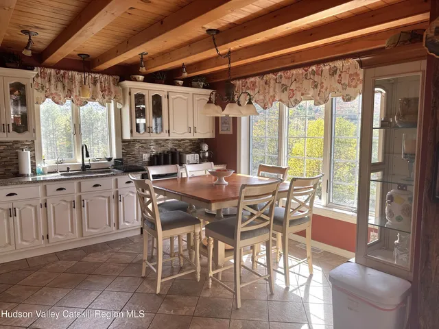 a dining table with chairs and window