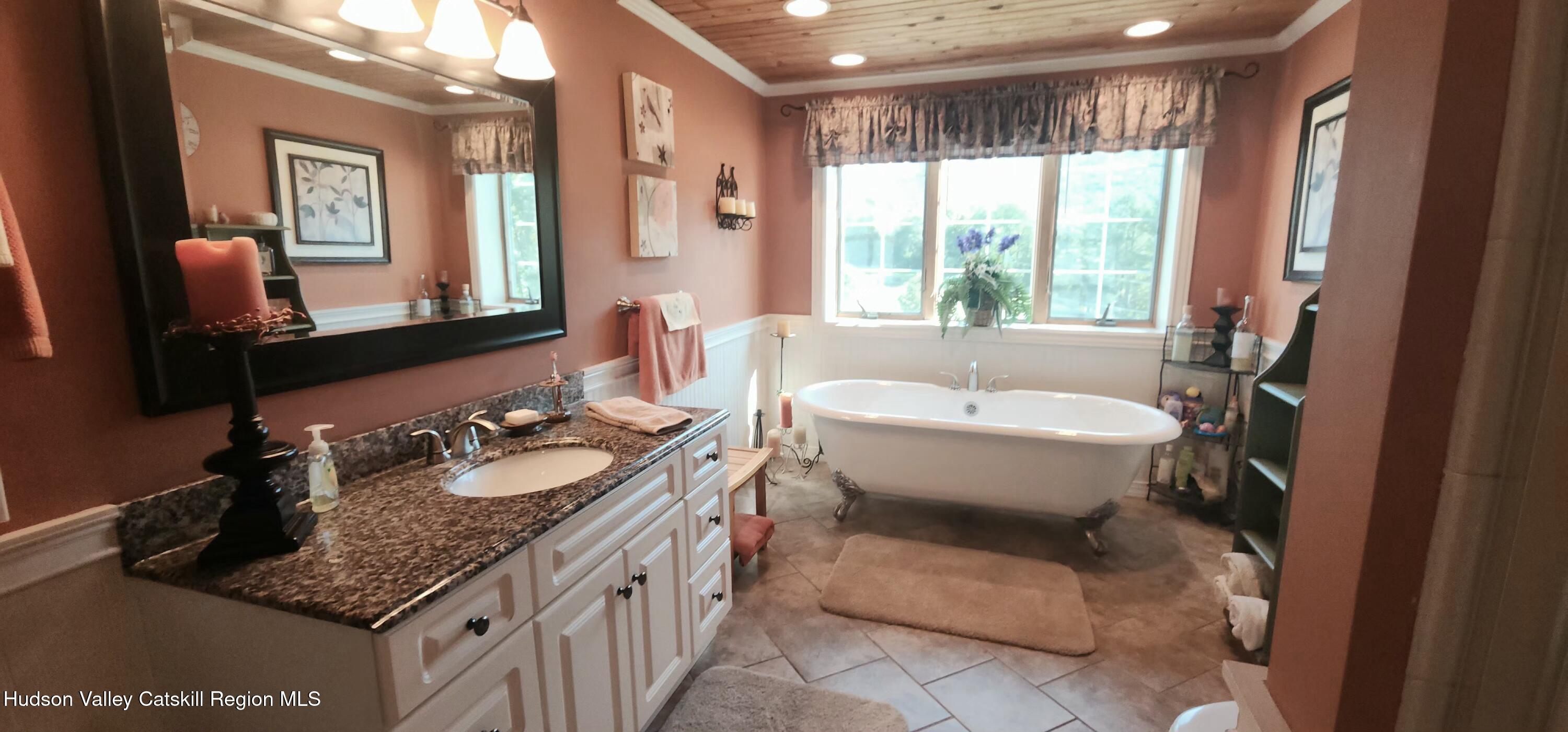 19 Pond View Road Ashland, NY 12468 - Photo 19 of 37 a bathroom with a granite countertop sink mirror and a bathtub