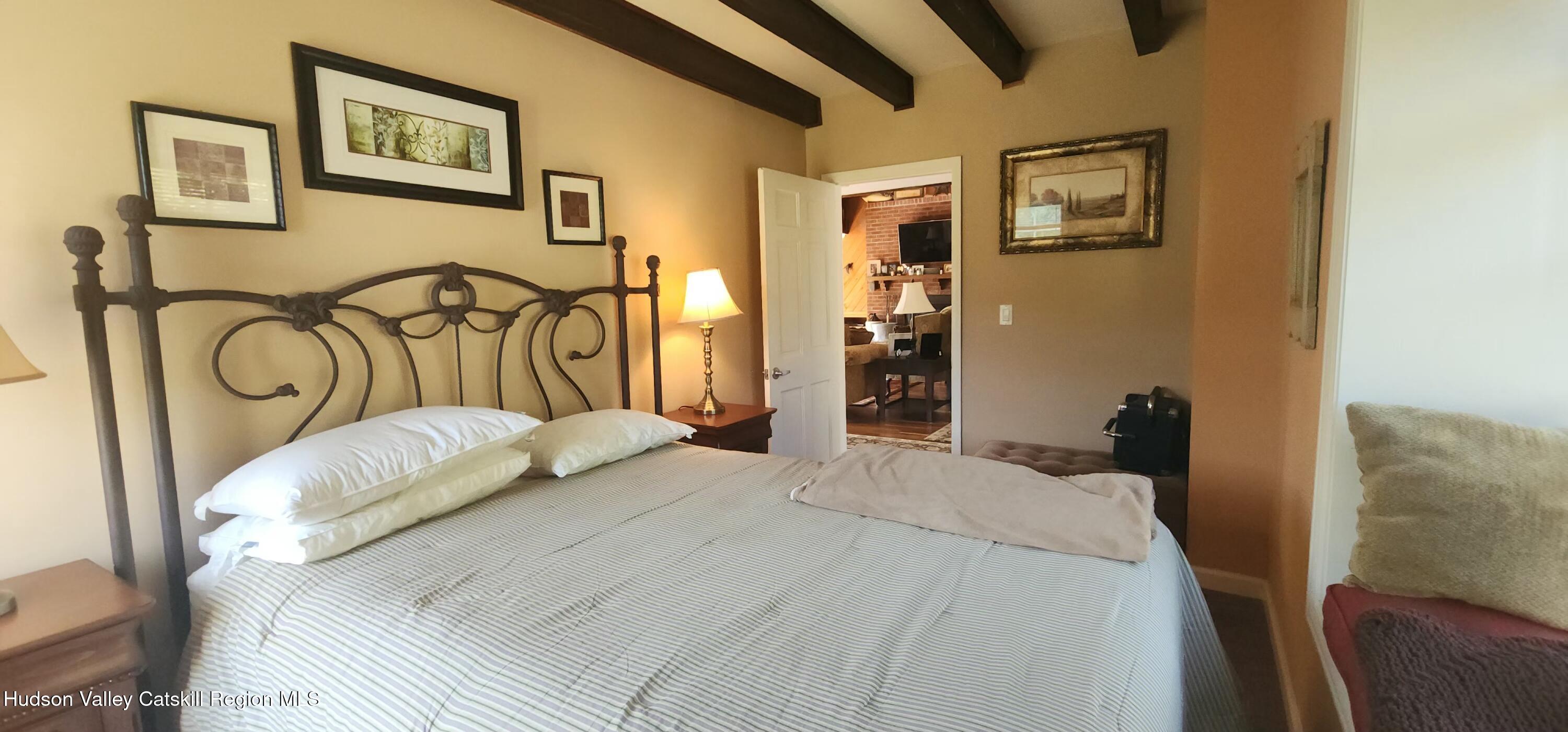 19 Pond View Road Ashland, NY 12468 - Photo 23 of 37 a bedroom with a bed and wall painting