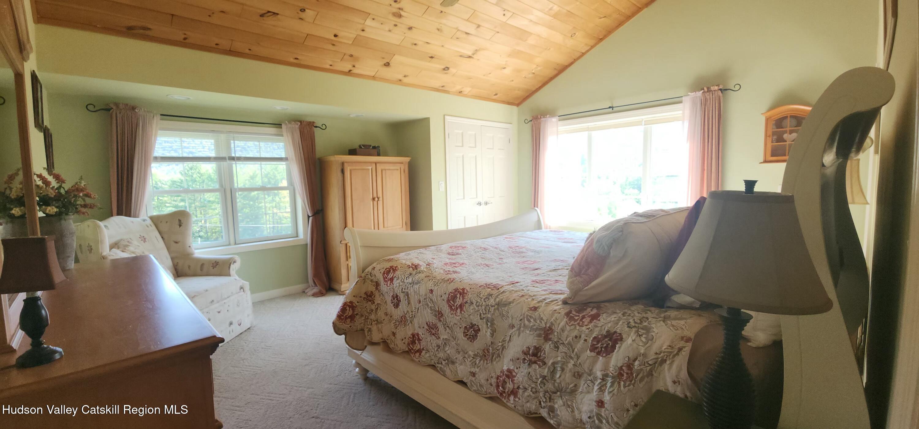 19 Pond View Road Ashland, NY 12468 - Photo 25 of 37 a bed sitting in a bedroom next to a window