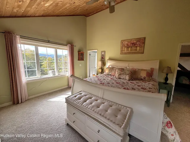 a bathroom with a granite countertop sink a mirror and shower