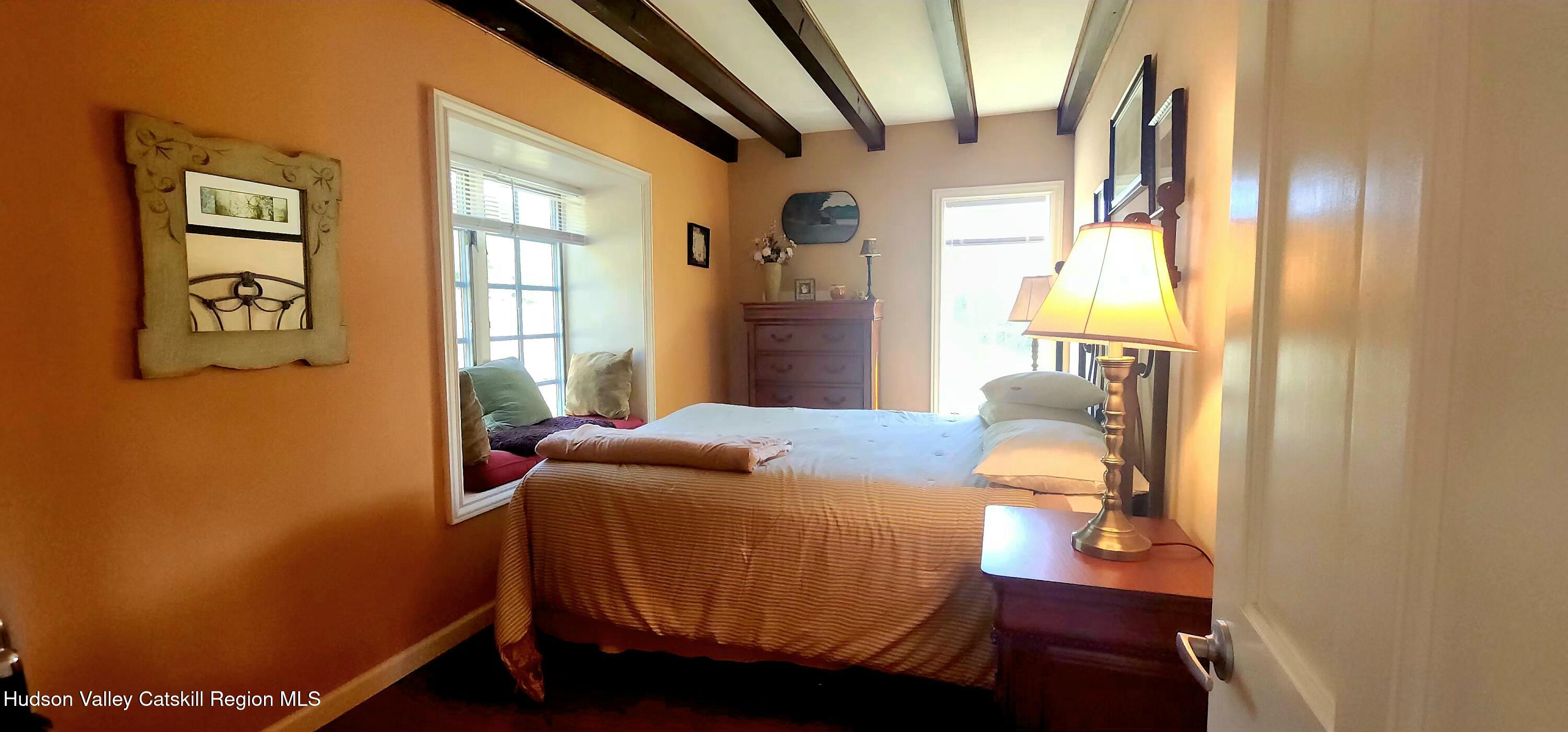 19 Pond View Road Ashland, NY 12468 - Photo 28 of 37 a bed sitting in a bedroom next to a window