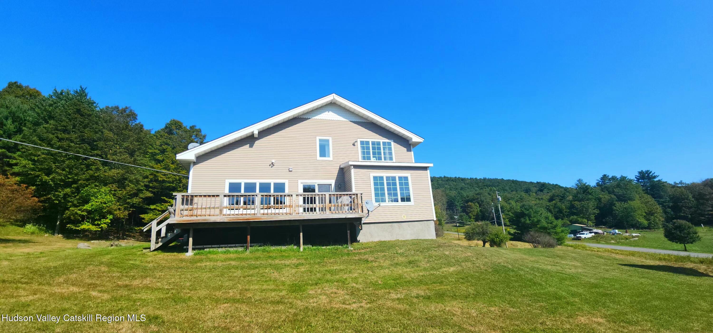 19 Pond View Road Ashland, NY 12468 - Photo 3 of 37 a white house with a small yard and wooden fence