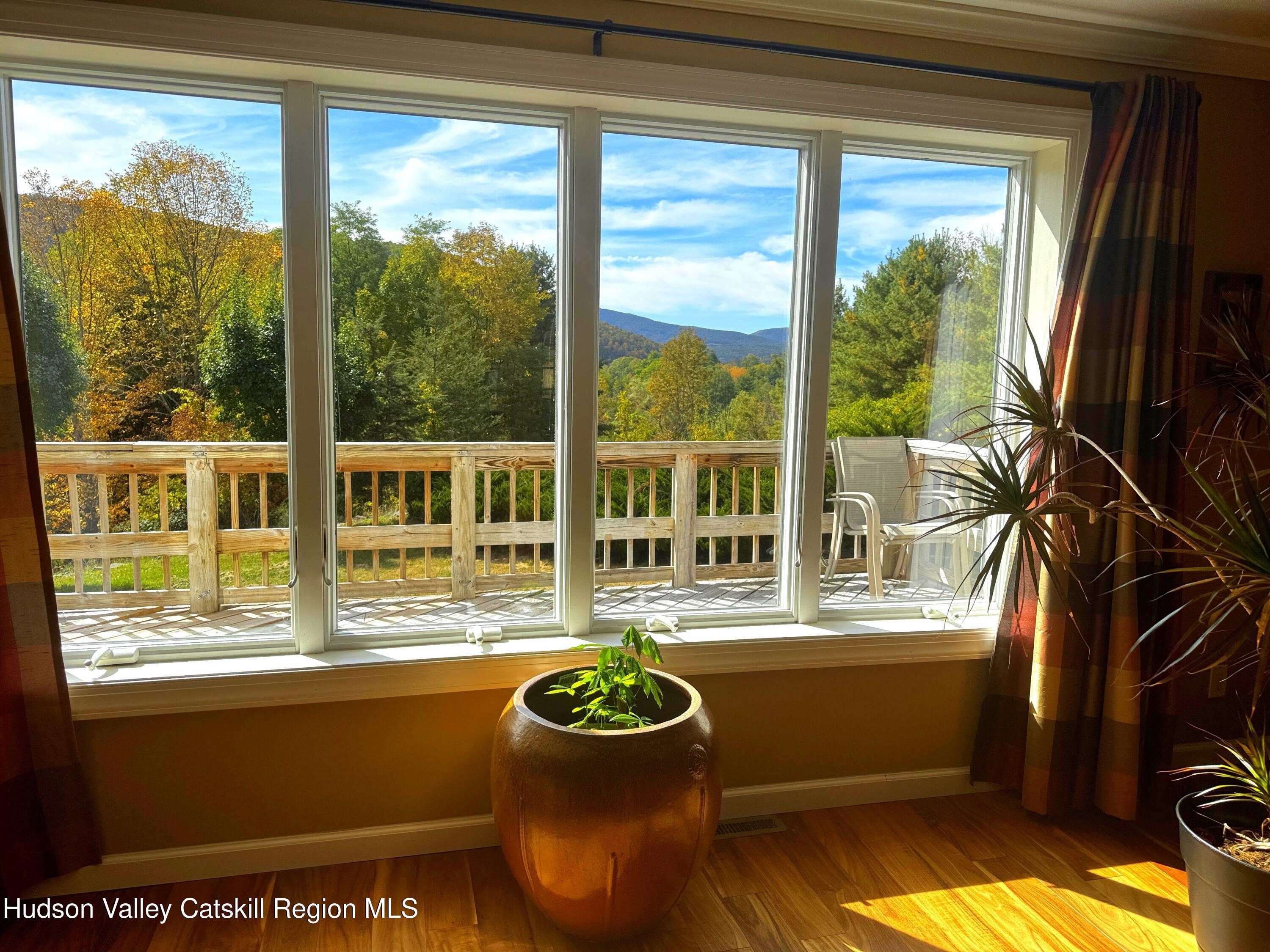 19 Pond View Road Ashland, NY 12468 - Photo 4 of 37 a living room with a large window and dining table