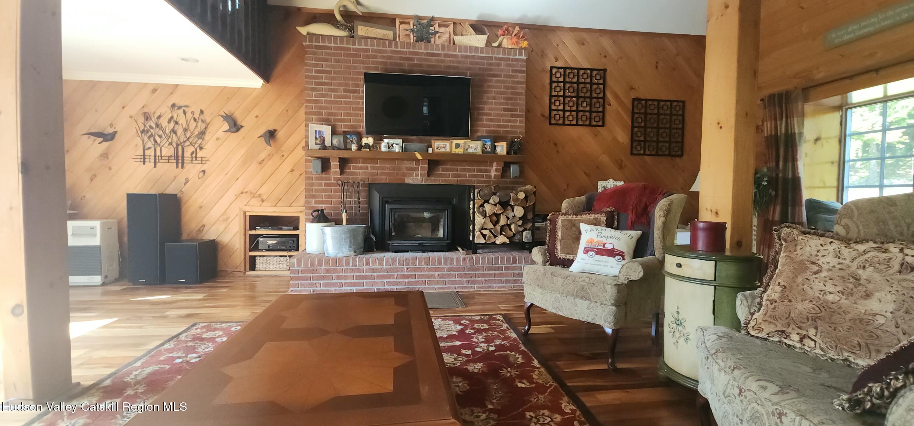 19 Pond View Road Ashland, NY 12468 - Photo 10 of 37 a living room with furniture a flat screen tv and a fireplace