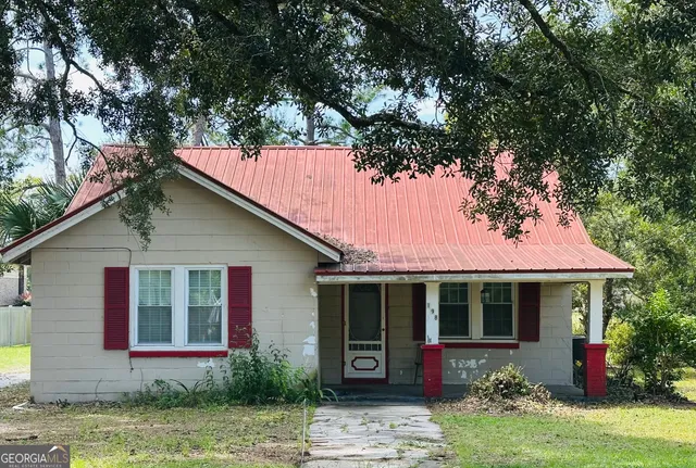 a front view of a house with garden
