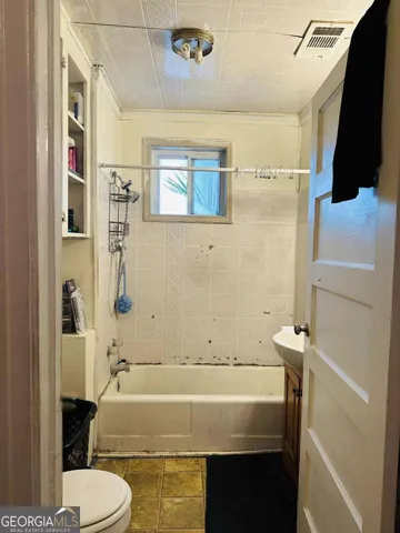 a bedroom with a bed and a mirror