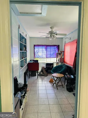 a room with furniture a rug and a window