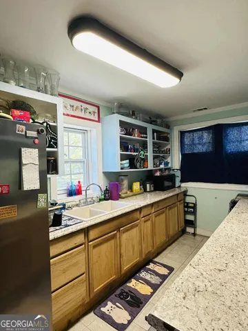a kitchen with storage and utility