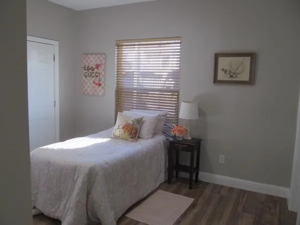 a bedroom with a bed and a window
