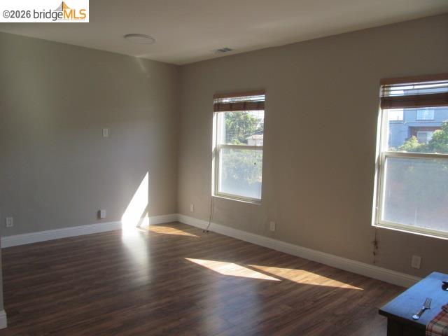 2807 Filbert Street Oakland, CA 94608 - Photo 4 of 12 a view of an empty room with wooden floor and a window