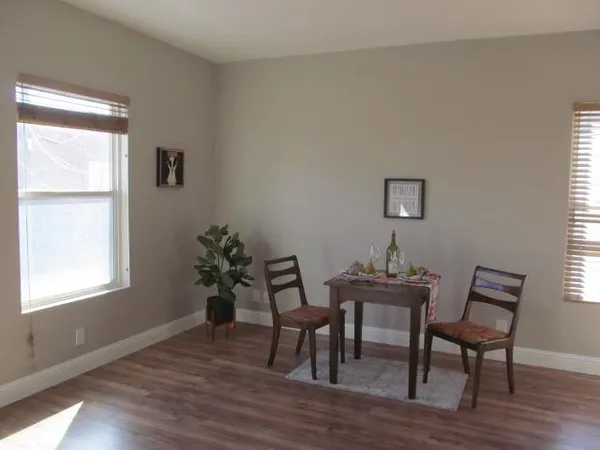 a dining room with furniture and wooden floor