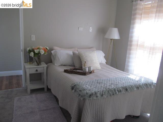 2807 Filbert Street Oakland, CA 94608 - Photo 8 of 12 a bedroom with a bed and a lamp on table