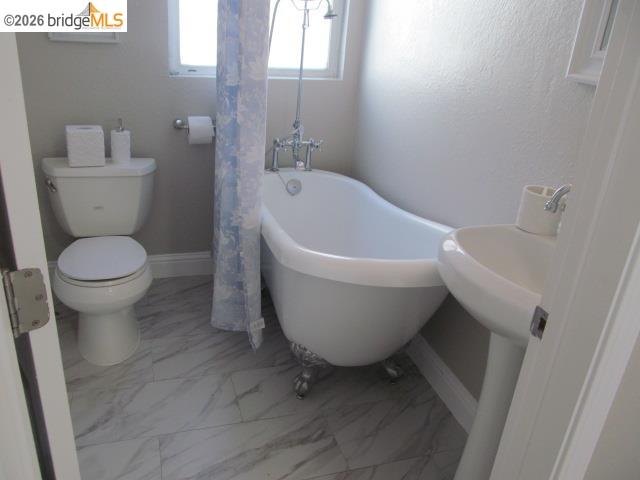 2807 Filbert Street Oakland, CA 94608 - Photo 9 of 12 a white toilet sitting next to a white sink