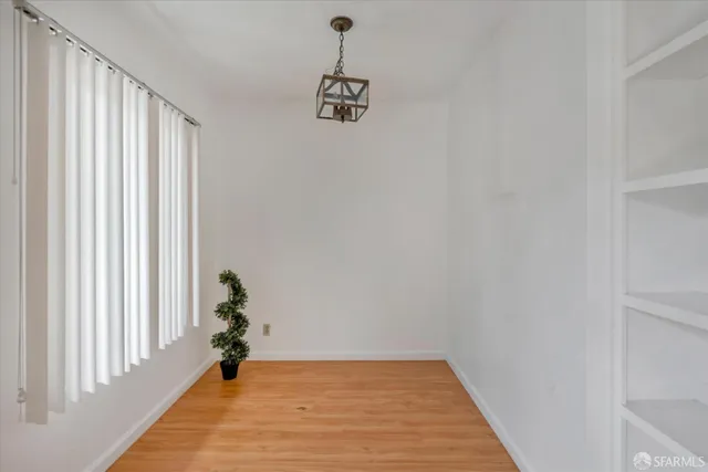 a view of a entrance and room with wooden floor