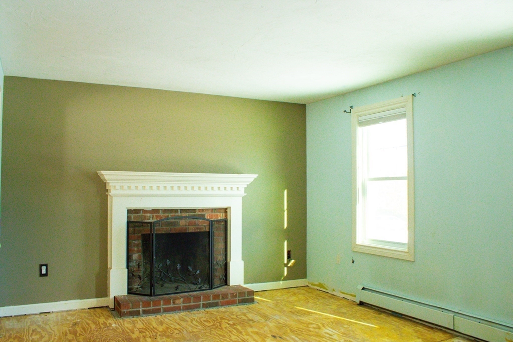 25 Bear Hill Road Gardner, MA 01440 - Photo 16 of 39 a view of a livingroom with a fireplace and a window