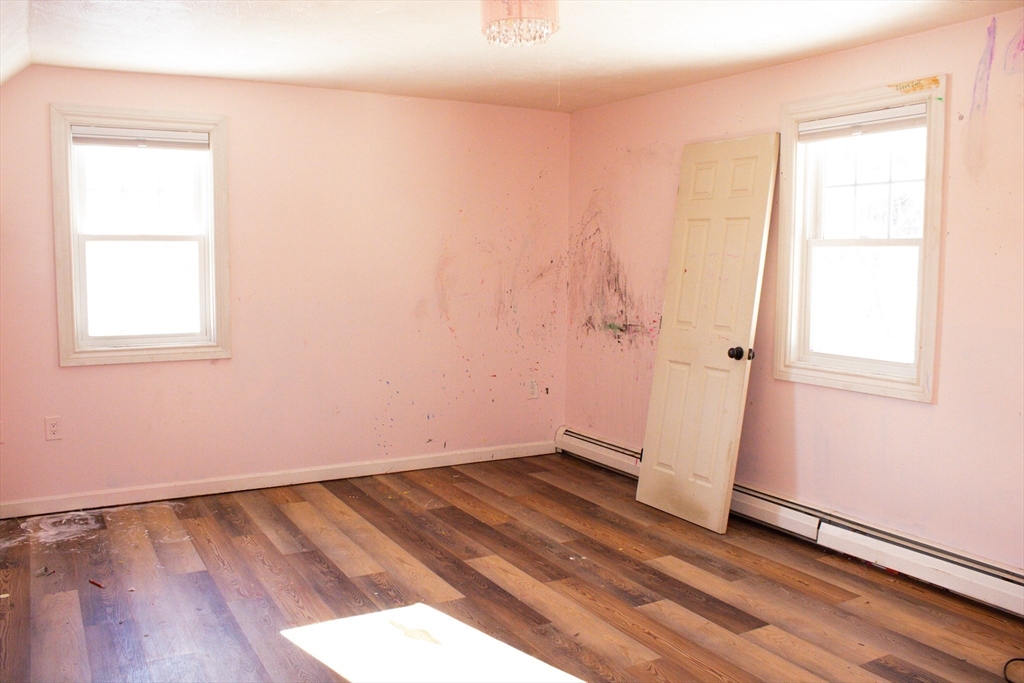 25 Bear Hill Road Gardner, MA 01440 - Photo 22 of 39 an empty room with wooden floor and windows