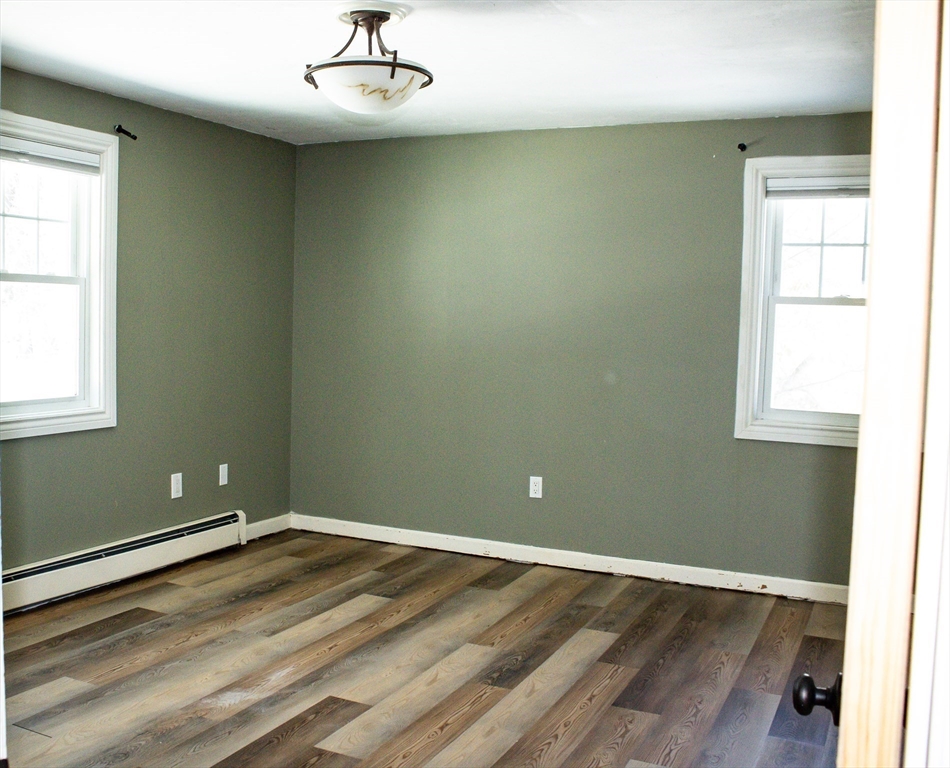 25 Bear Hill Road Gardner, MA 01440 - Photo 29 of 39 an empty room with wooden floor and windows