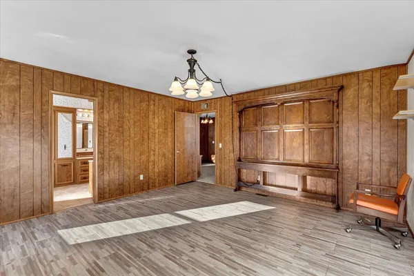 a bedroom with a bed and a chandelier