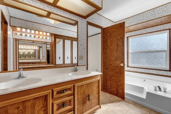 a bathroom with a granite countertop sink mirror and double