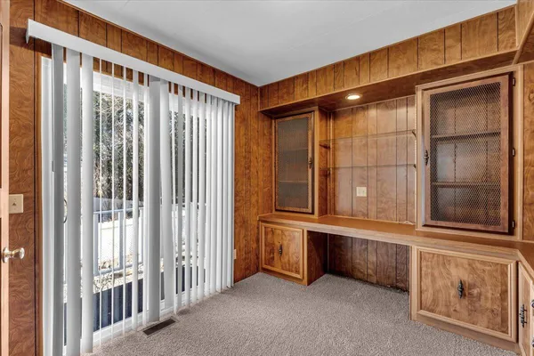 a view of a refrigerator a sink and cabinets